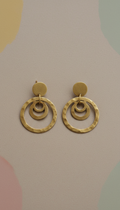 Artisanal brass earrings with bold motifs